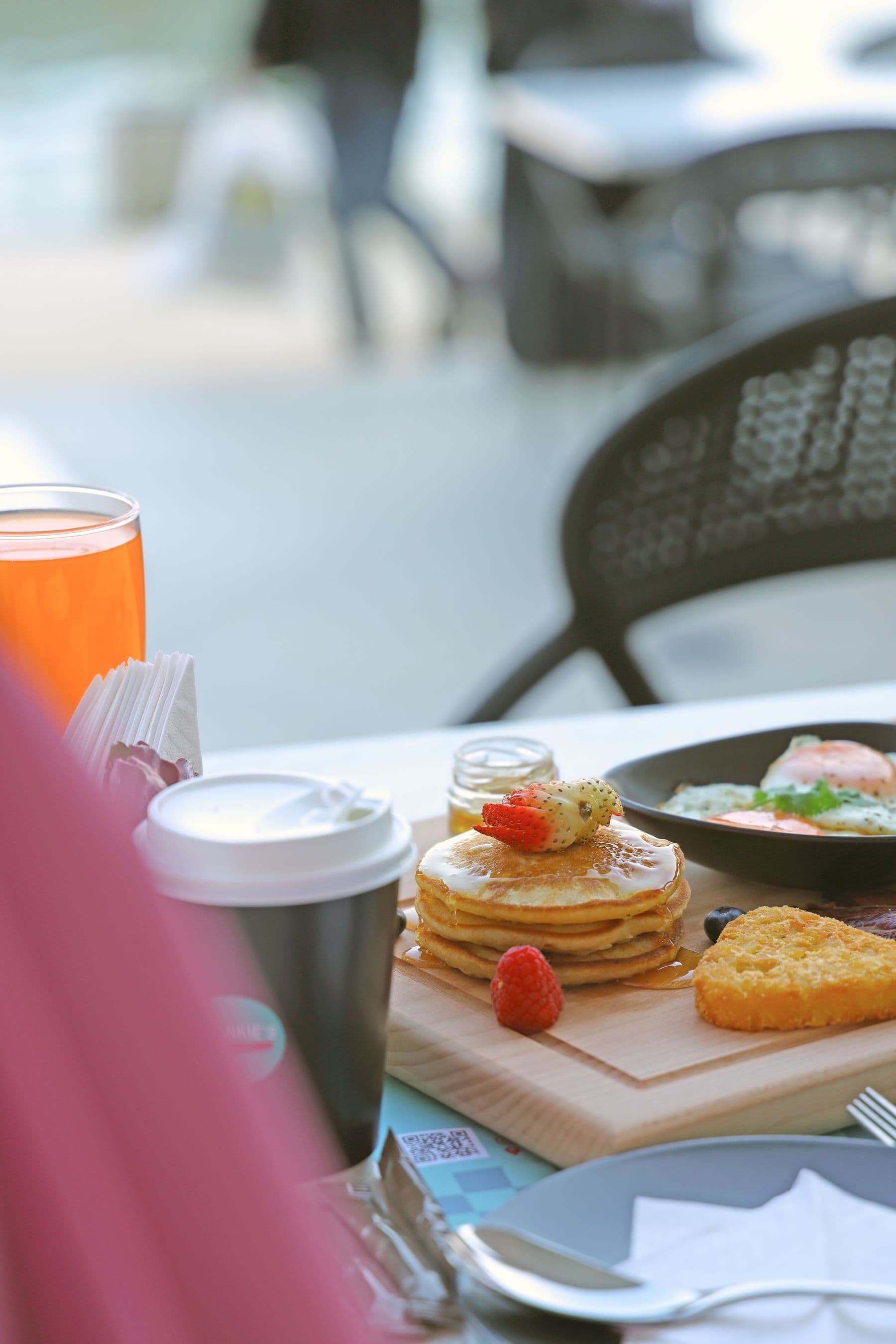 Pancakes, coffee and toast on a café table