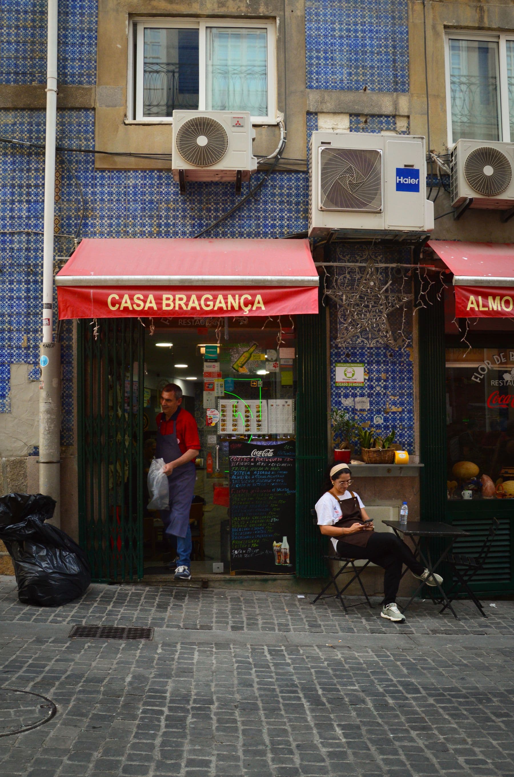 Traditional restaurant exterior with blue tiles in central Porto