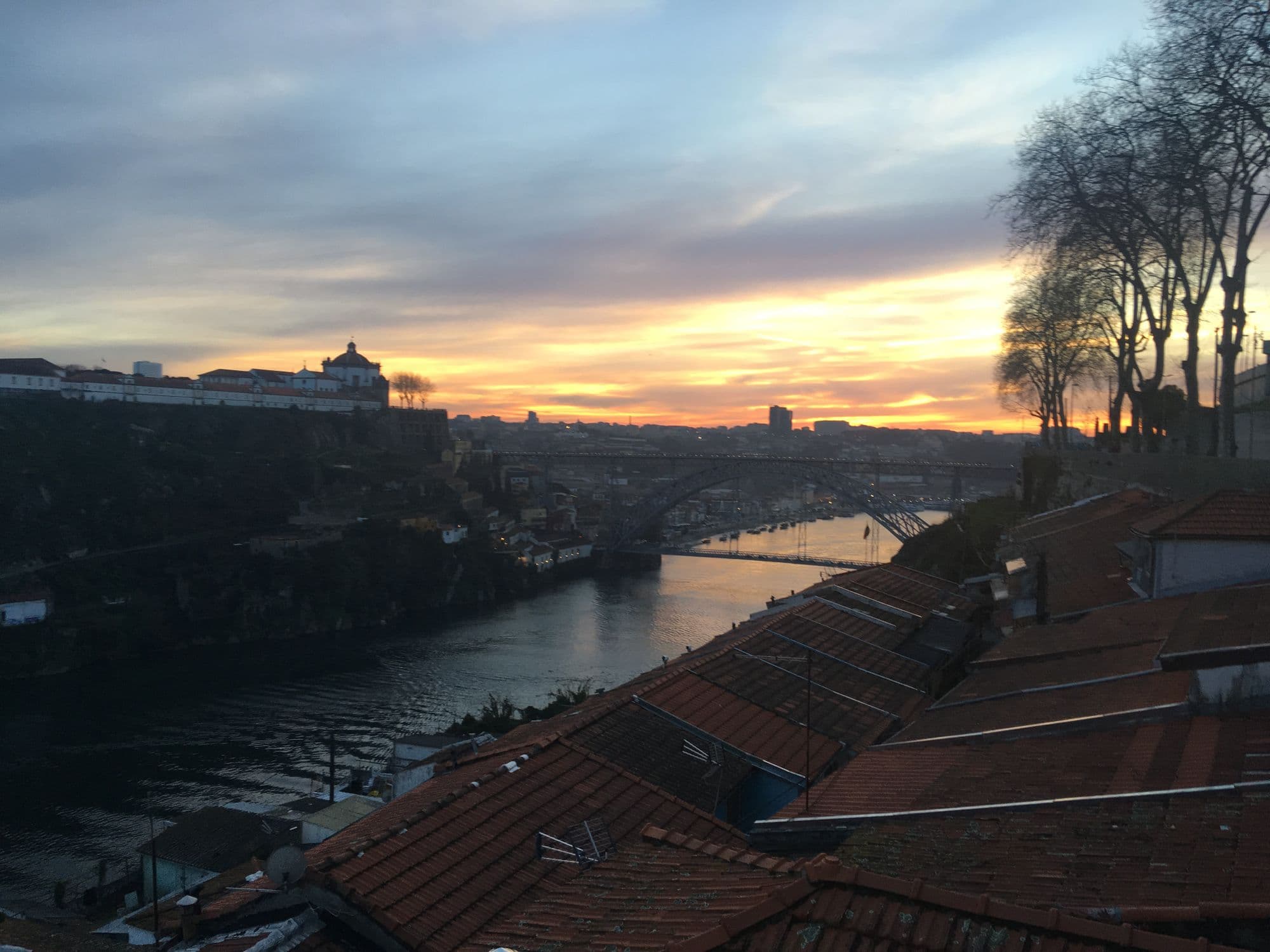 Porto rooftops, the Douro and Dom Luís I Bridge at sunset