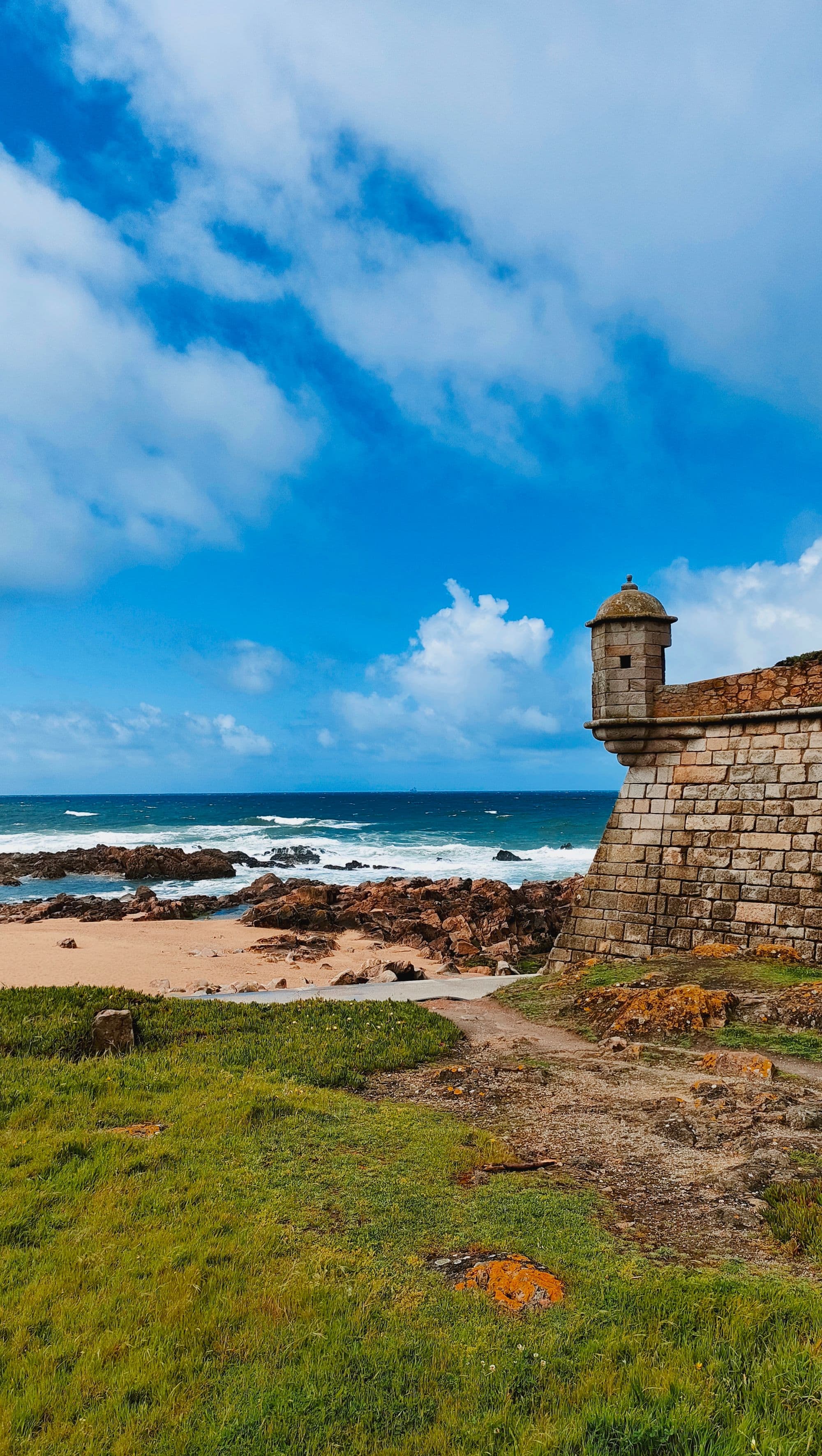 Rocky Atlantic beach and historic fort walls in Foz do Douro