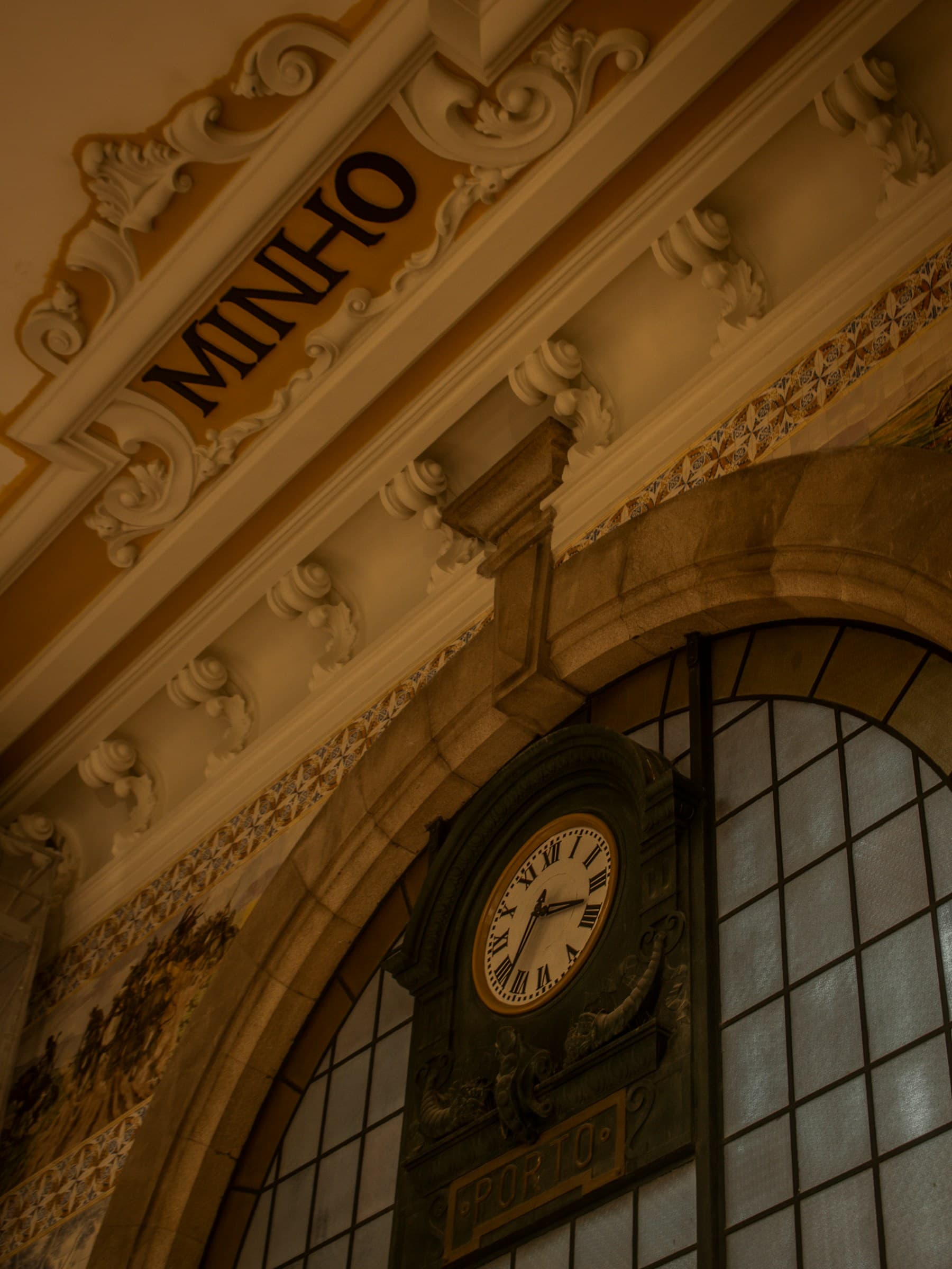 The clock and interior of São Bento railway station in Porto
