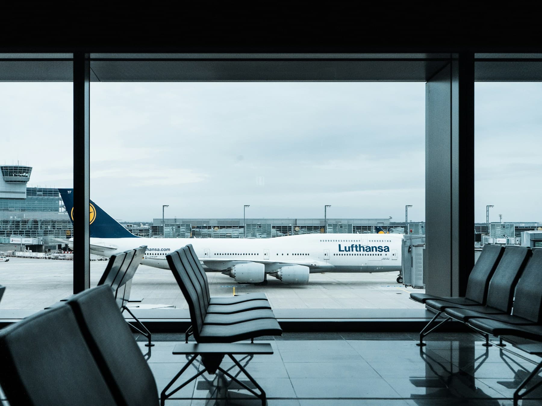 An aircraft parked beside an airport terminal
