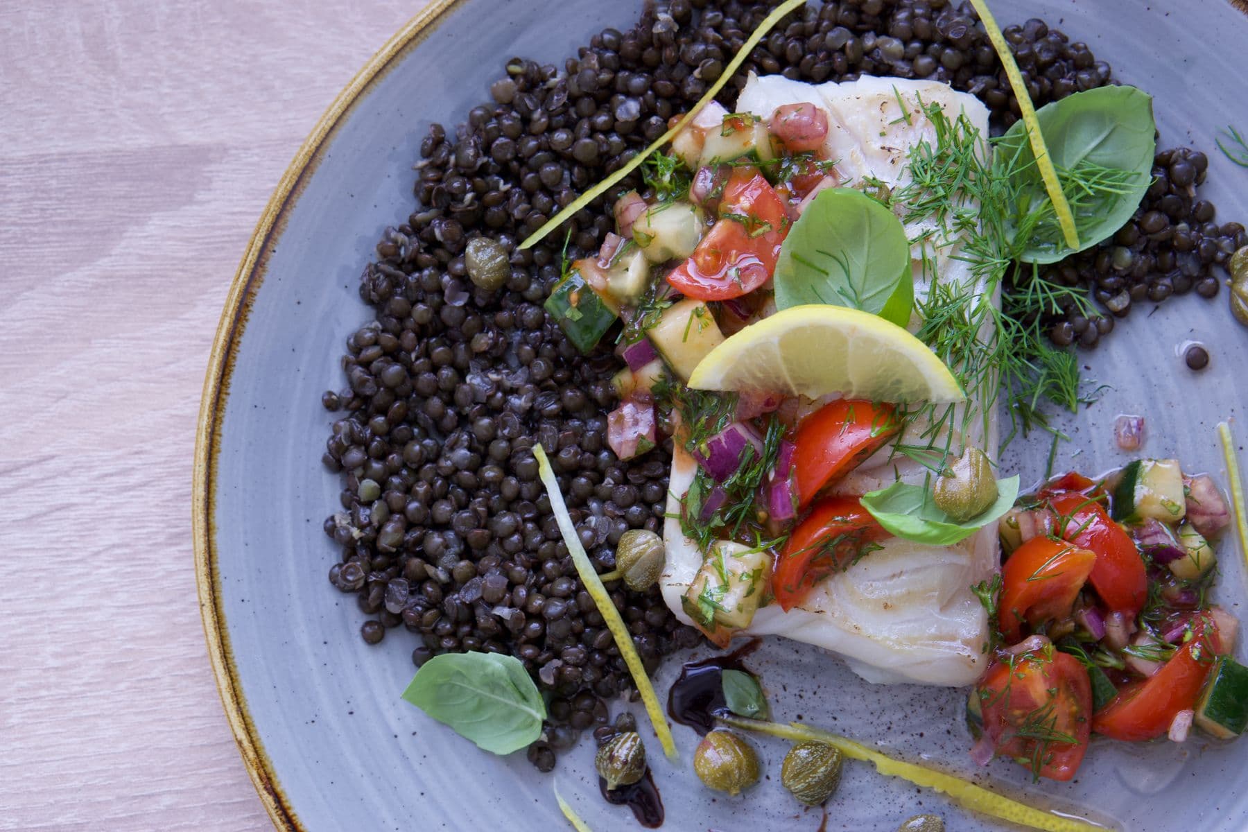Cod dish served with lentils, salsa and fresh herbs