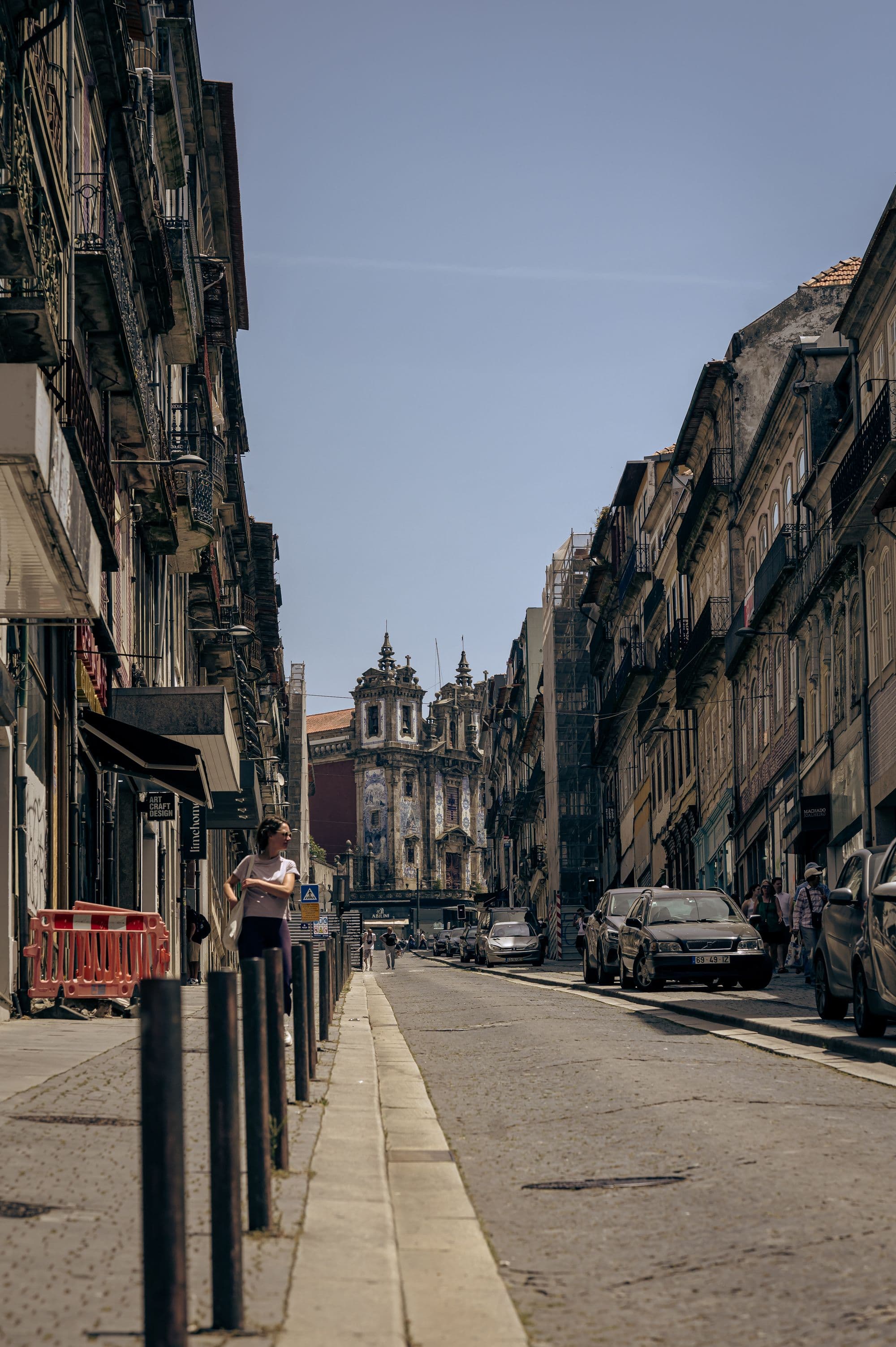 Historic central Porto street leading towards a tiled church