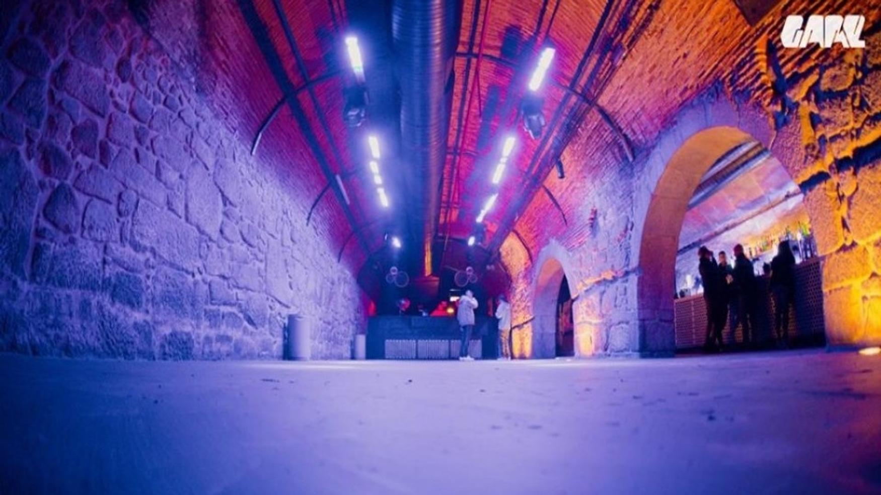 Vaulted stone dancefloor and DJ booth inside Gare Porto
