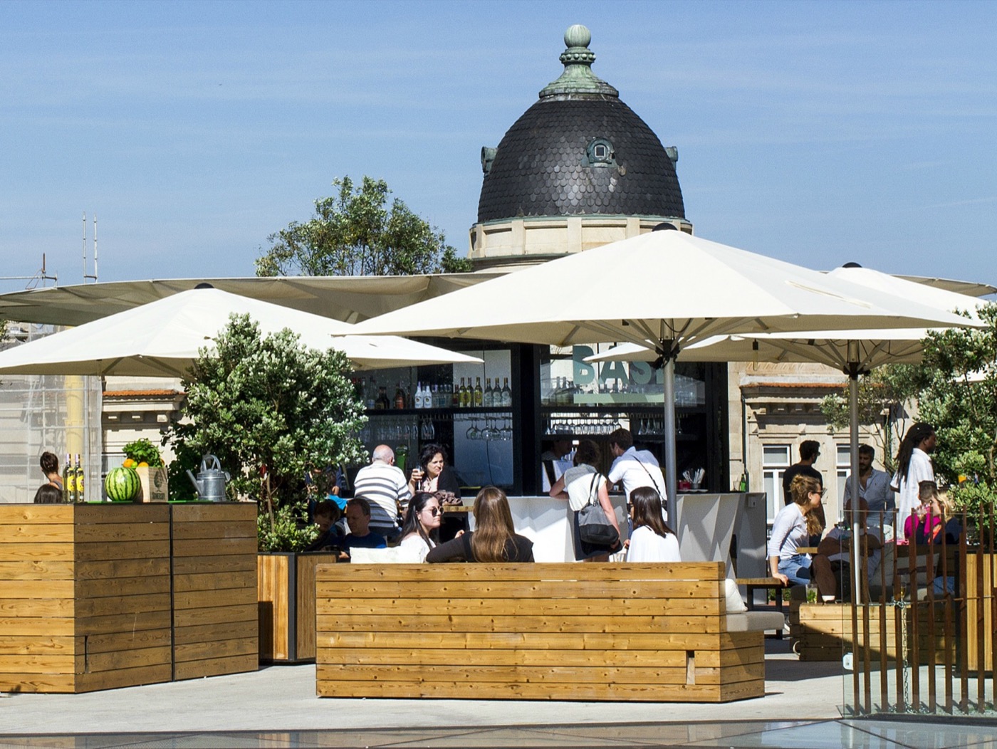 Outdoor bar and umbrellas at BASE Porto beside Clérigos