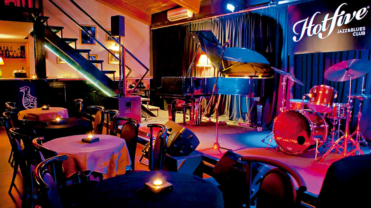 Piano, drum kit and candlelit tables at Hot Five Jazz and Blues Club